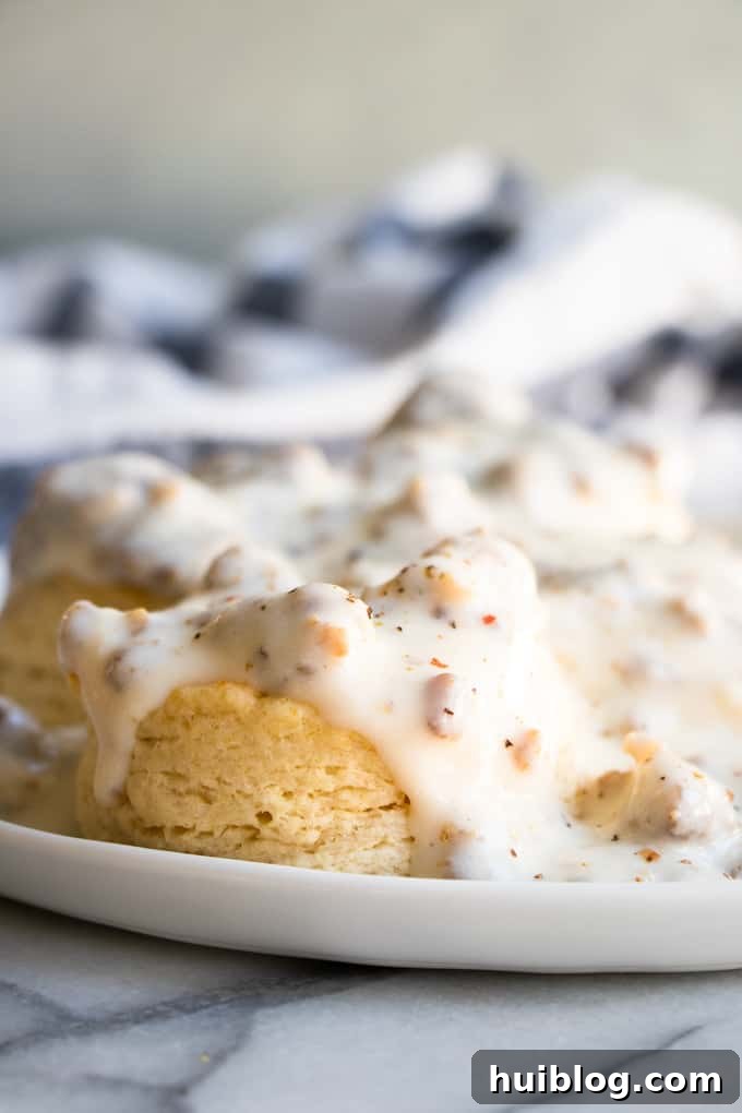Plate full of biscuits and gravy made with homemade sausage gravy. 