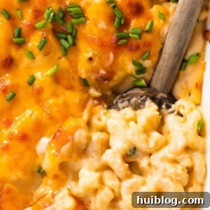Spoon serving up homemade baked macaroni and cheese.