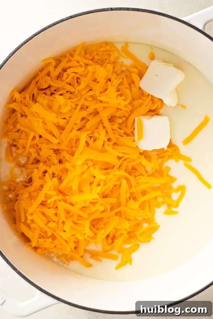 Golden Baked Mac and Cheese Made Easy 4 Butter and shredded cheese added to a roux for making homemade cheese sauce for macaroni and cheese.