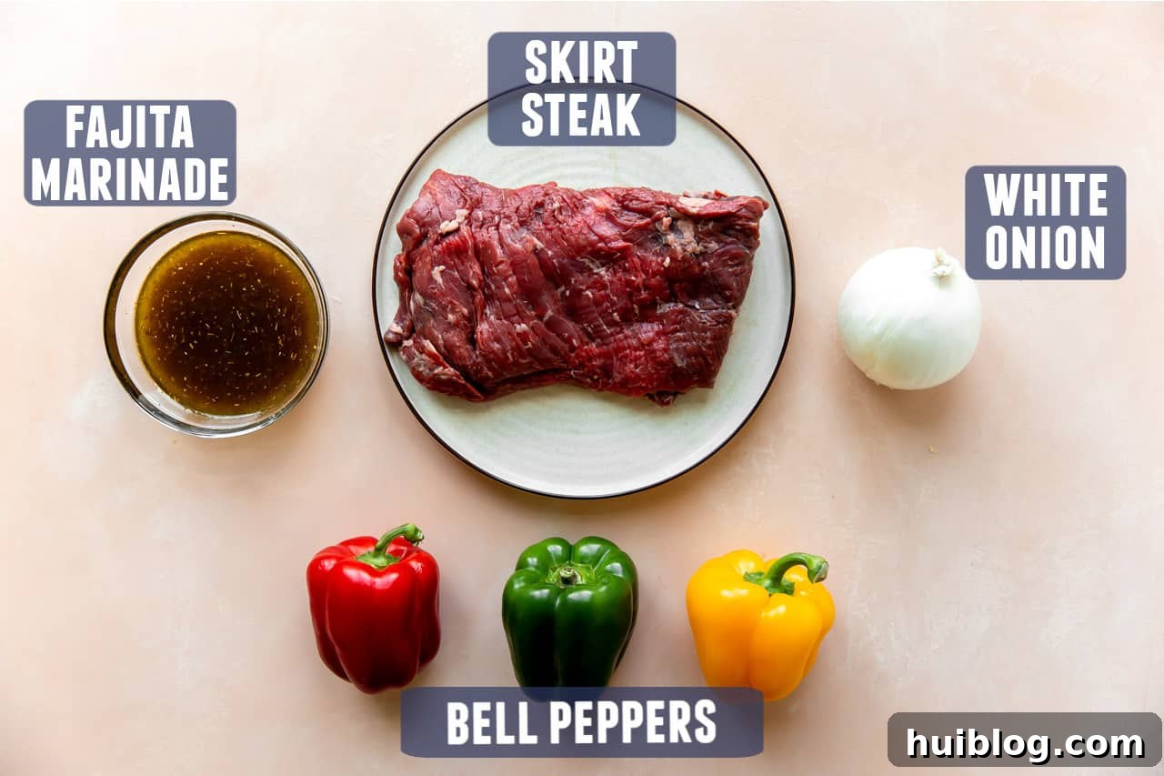 Ingredients for steak fajitas laid out on a counter, including bell peppers, onions, steak, and marinade components.