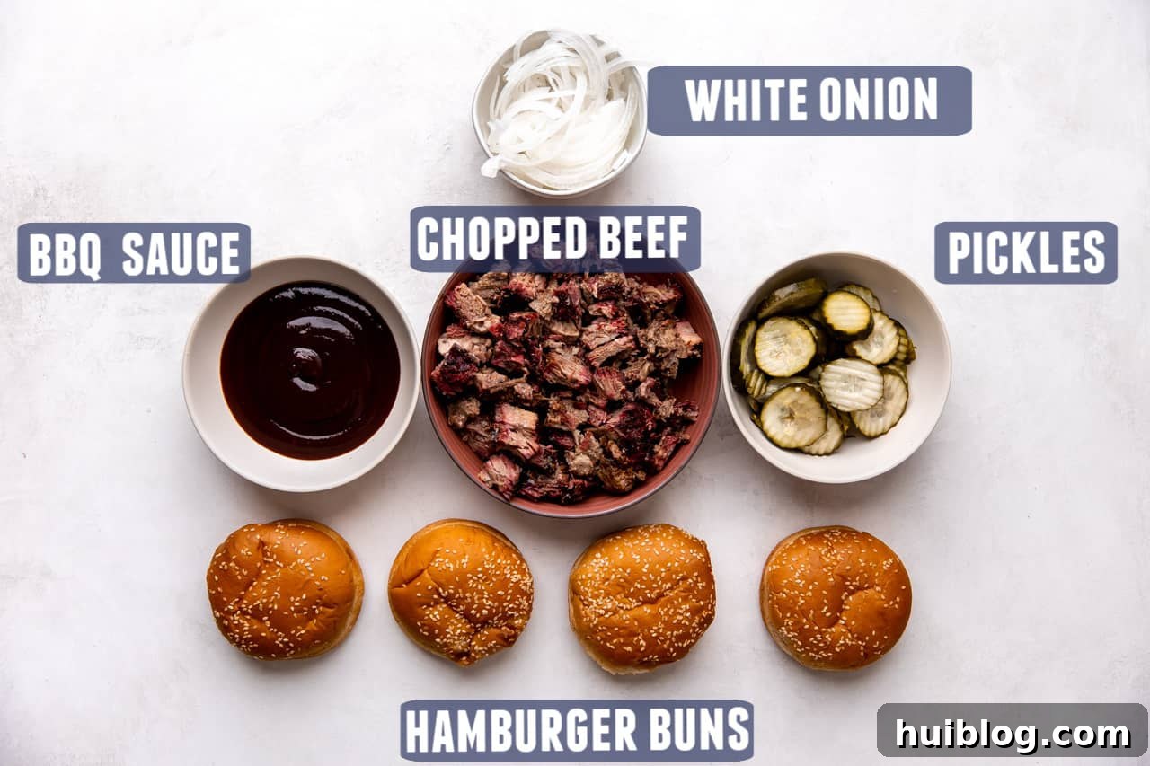 Pulled Pork BBQ Sandwiches 3 The array of simple yet essential ingredients needed to assemble a delicious chopped beef sandwich, neatly arranged on a kitchen counter.