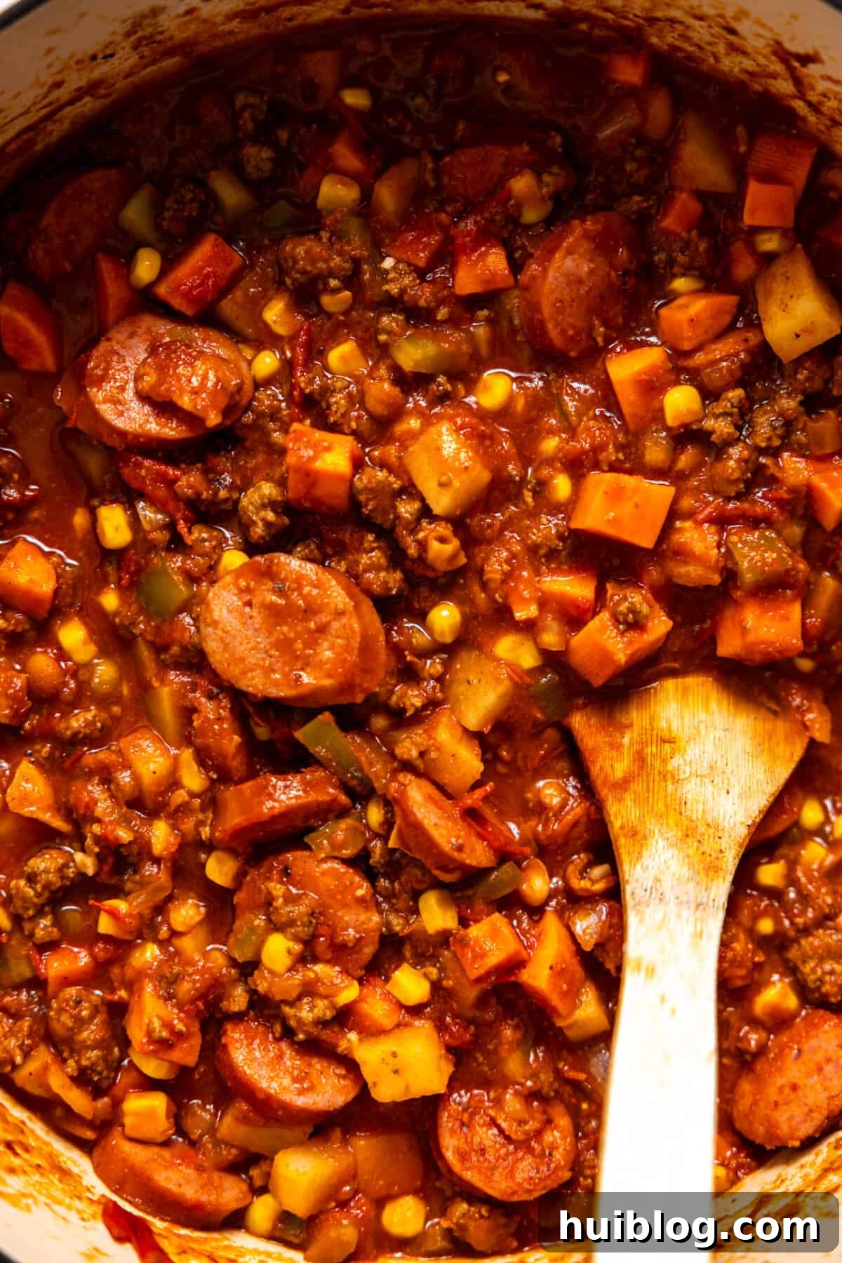Chuck Wagon Comfort Stew 6 Pot of cooked cowboy stew with a wooden spoon ready to serve.