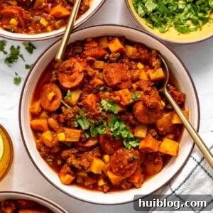 Chuck Wagon Comfort Stew 4 Bowls served with cowboy stew and topped with fresh parsley.