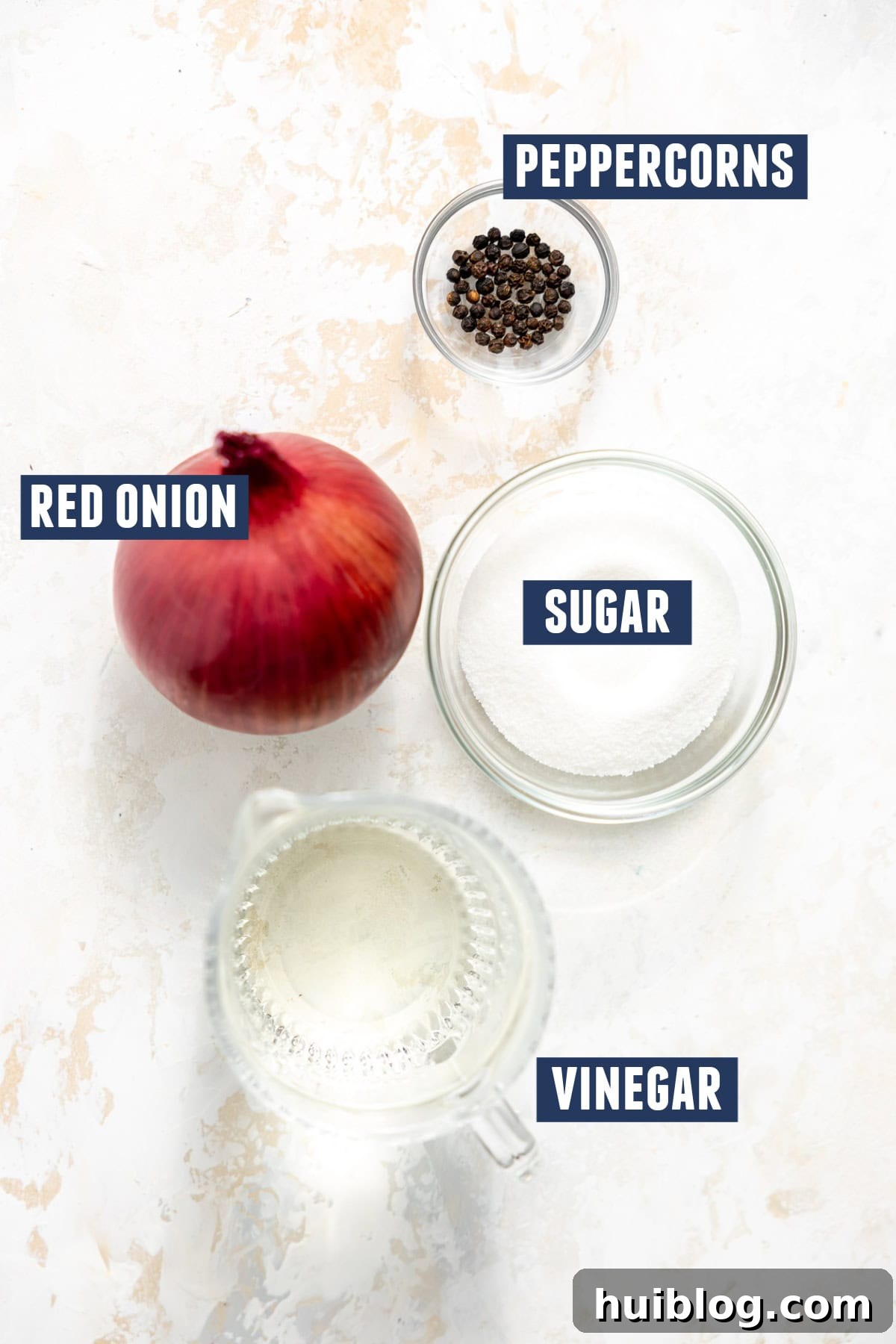 My Secret Weapon Pickled Red Onions 5 Ingredients needed to make pickled red onion including the red onion, peppercorns, sugar, and vinegar.