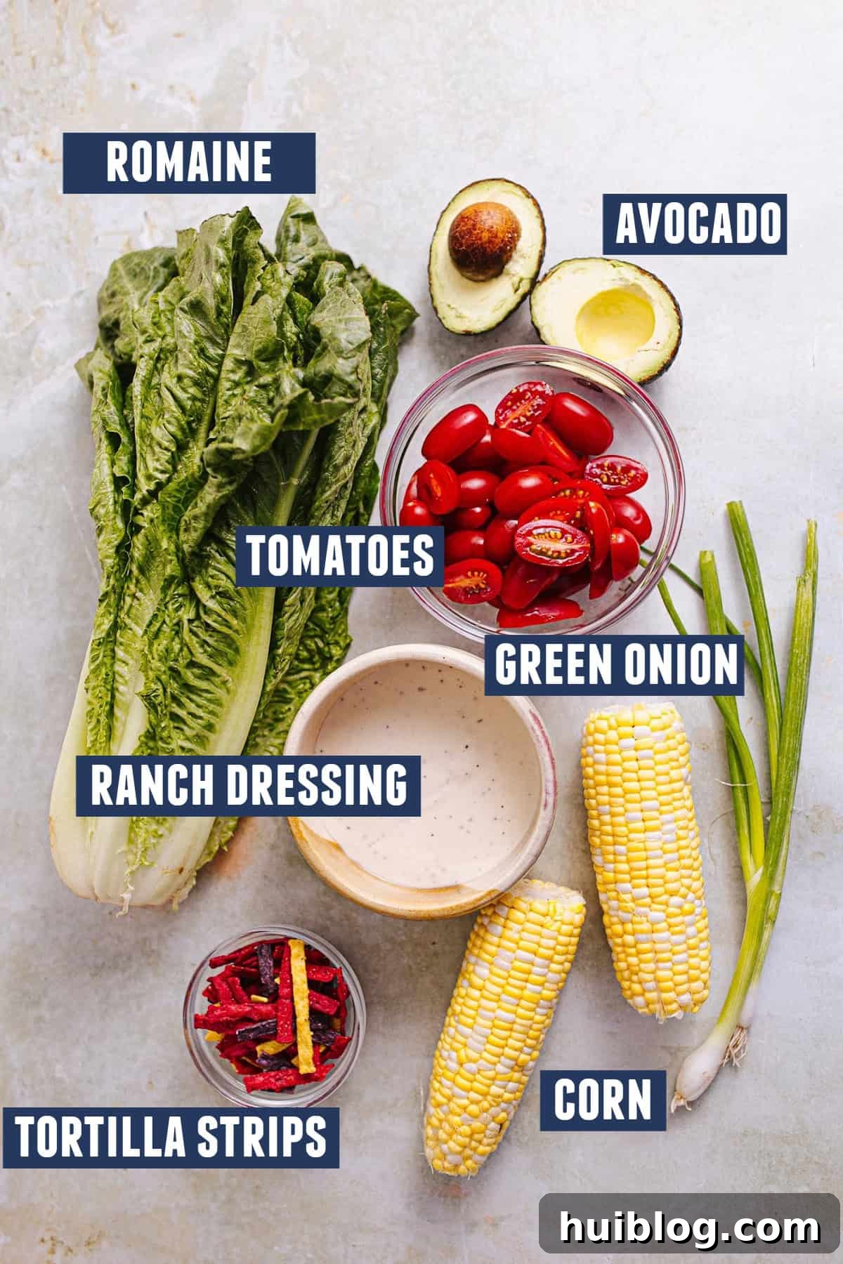 BBQ Chicken Salad Delights 5 A selection of fresh produce and ingredients for a vibrant BBQ Chicken Salad, including crisp romaine lettuce, sweet corn, and ripe grape tomatoes, ready for assembly.