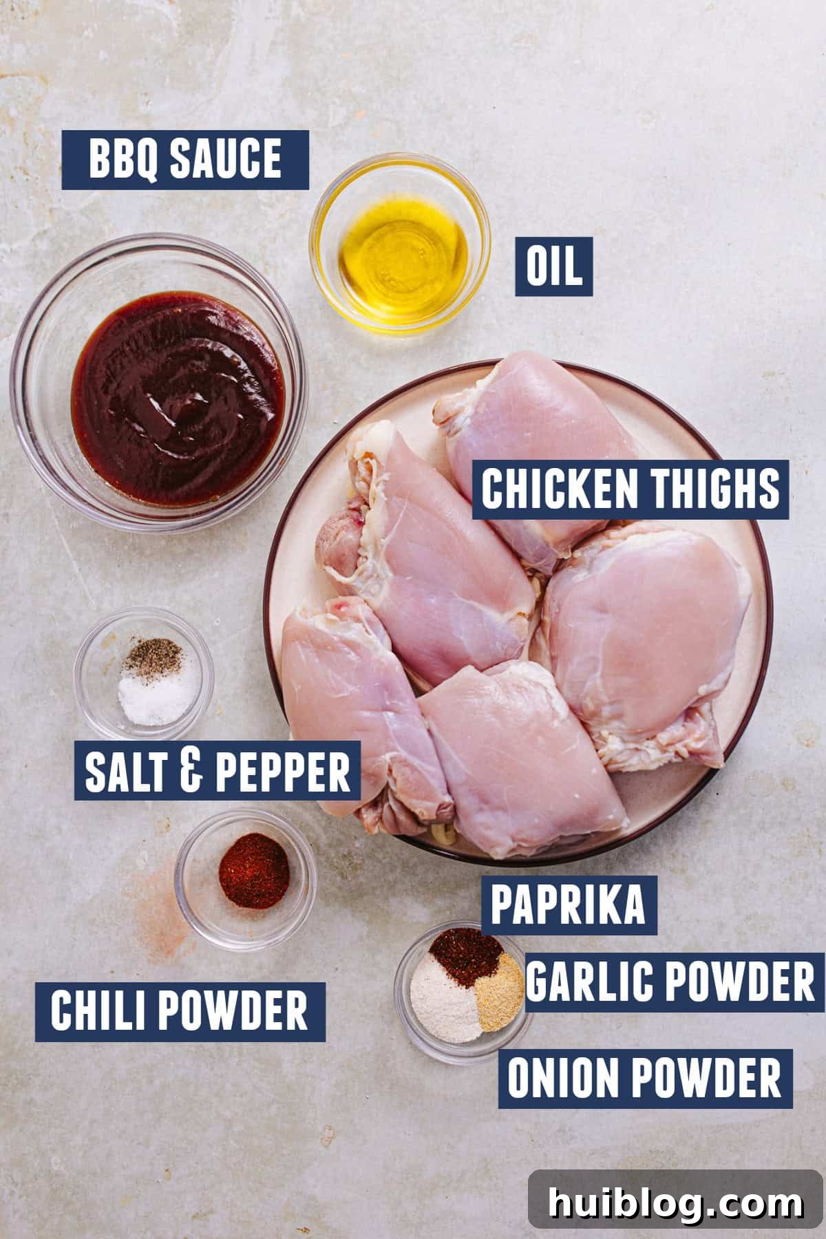 BBQ Chicken Salad Delights 6 Ingredients thoughtfully arranged for preparing delicious BBQ chicken, including raw boneless chicken thighs, a bottle of flavorful BBQ sauce, and a mix of aromatic spices.