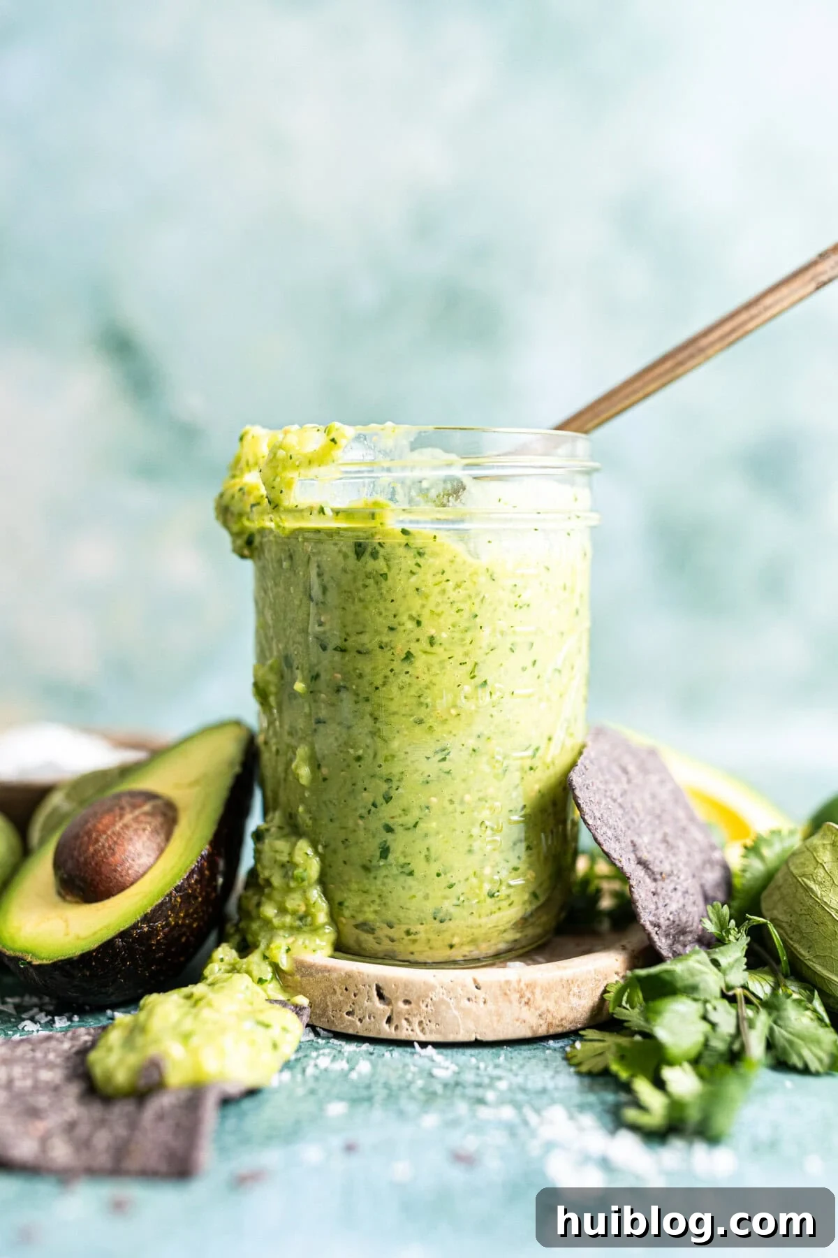 Ultimate Avocado Salsa 2 Jar of creamy avocado salsa, garnished with fresh cilantro and lime.