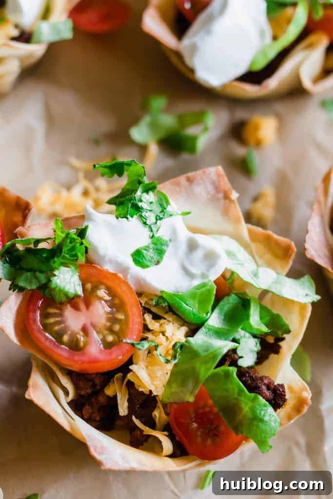 Taco Poppers 3 Taco Cups filled with uicy taco meat, melty cheese, shredded lettuce, tomato and sprinkled cilantro.