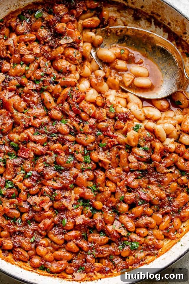 Sweet and Smoky Maple Bacon Baked Beans 2 Pot of rich, homemade maple bacon baked beans, generously topped with crispy bacon.