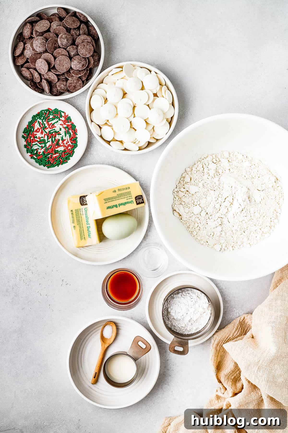 An overhead shot meticulously showcasing all the fresh, high-quality ingredients required to make delectable butter cookies, arranged neatly on a surface to inspire budding bakers.