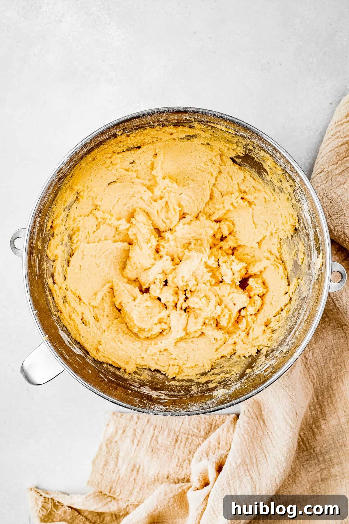 Overhead shot of a mixing bowl full of rich, creamy cookie dough, perfectly prepared for piping.