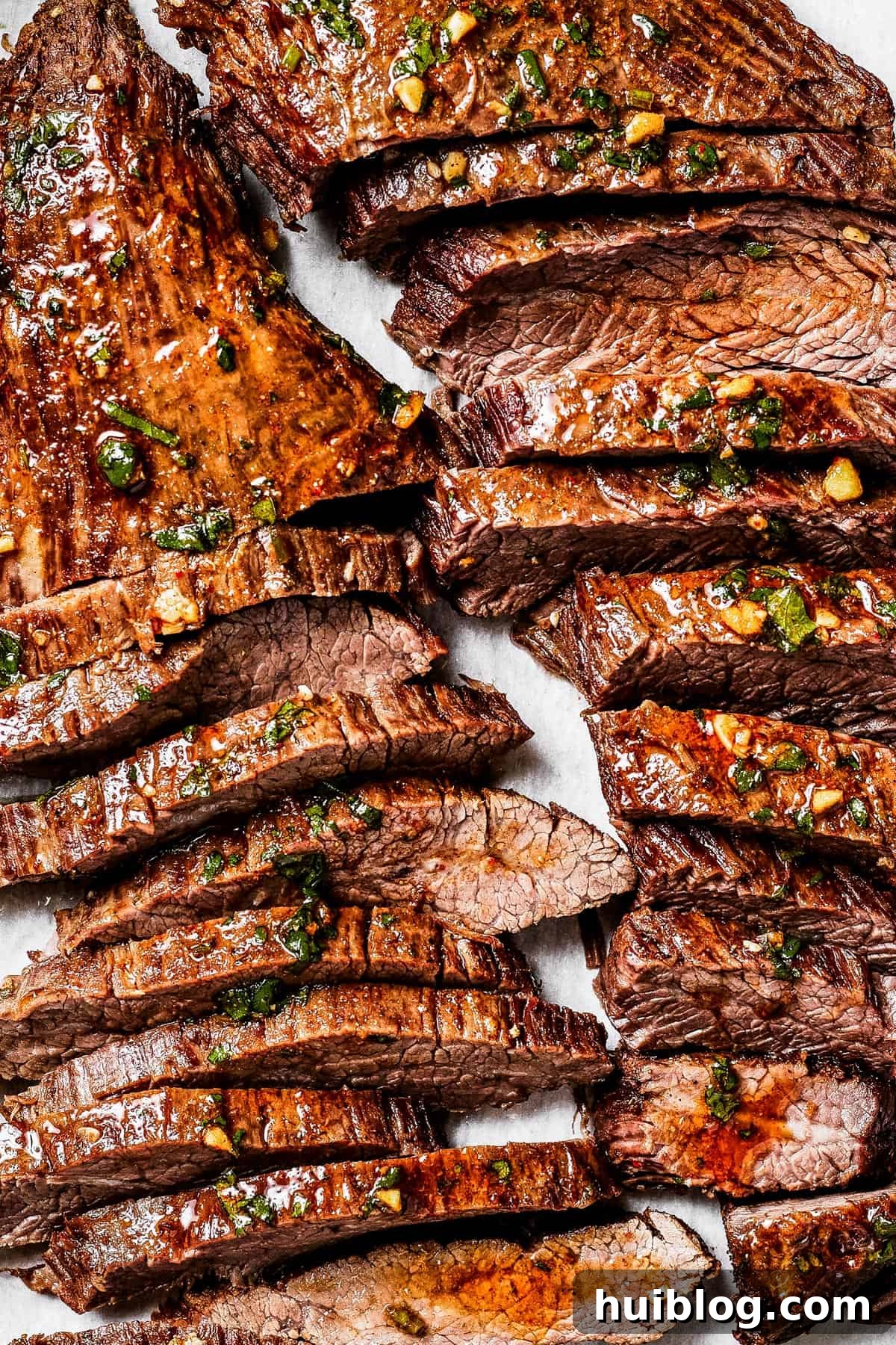 Sliced cooked steak on a cutting board, ready to serve.