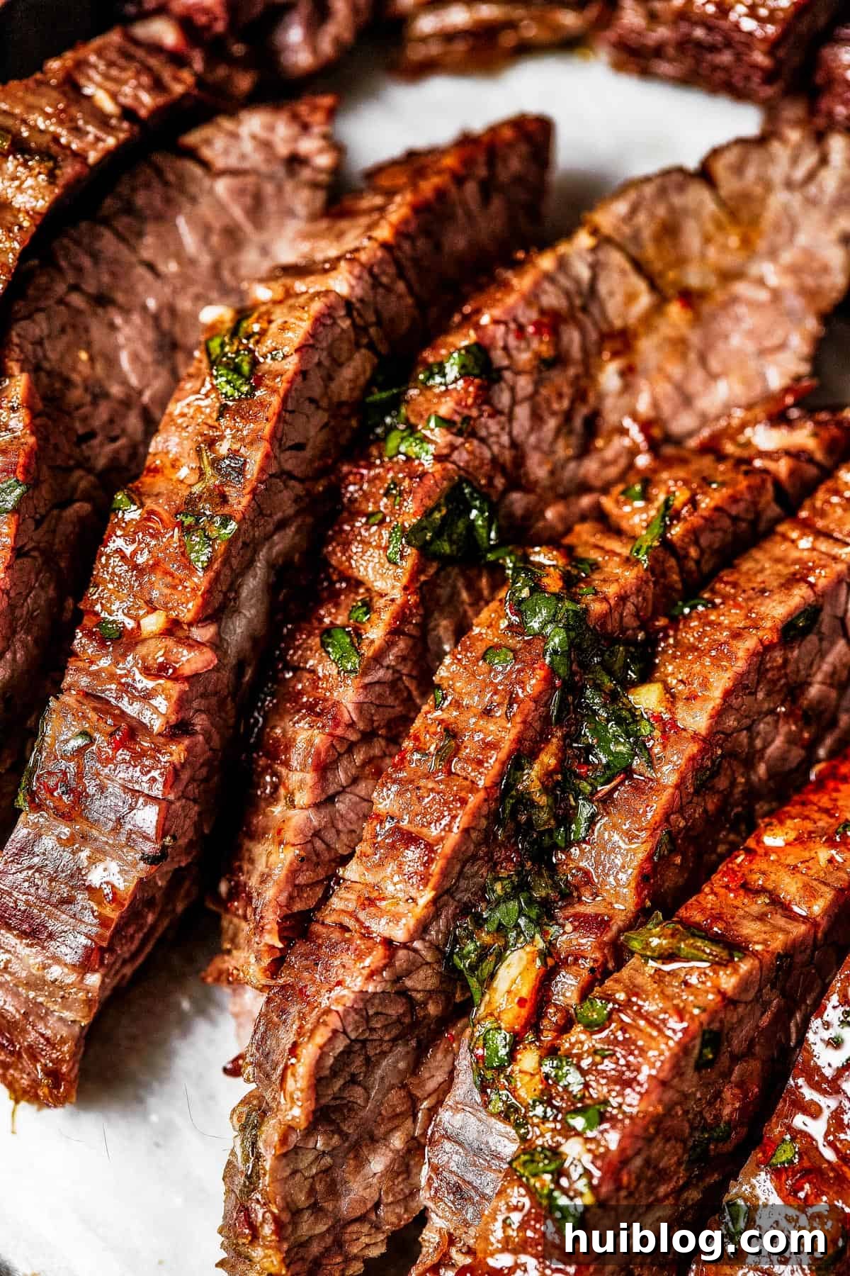 Close-up shot of perfectly sliced, juicy steak with a vibrant sheen.