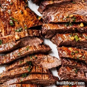 Sliced cooked steak on a cutting board.
