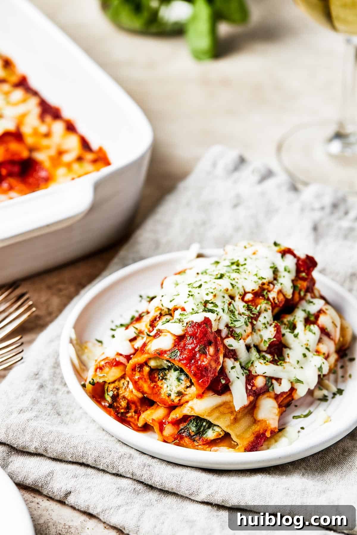 A single serving of warm cheese pasta, with melted cheese and red sauce, artfully presented on a small white plate, ready to be enjoyed.