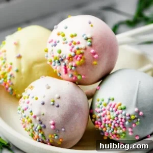 Pastel cake pop lollipops on a white plate.