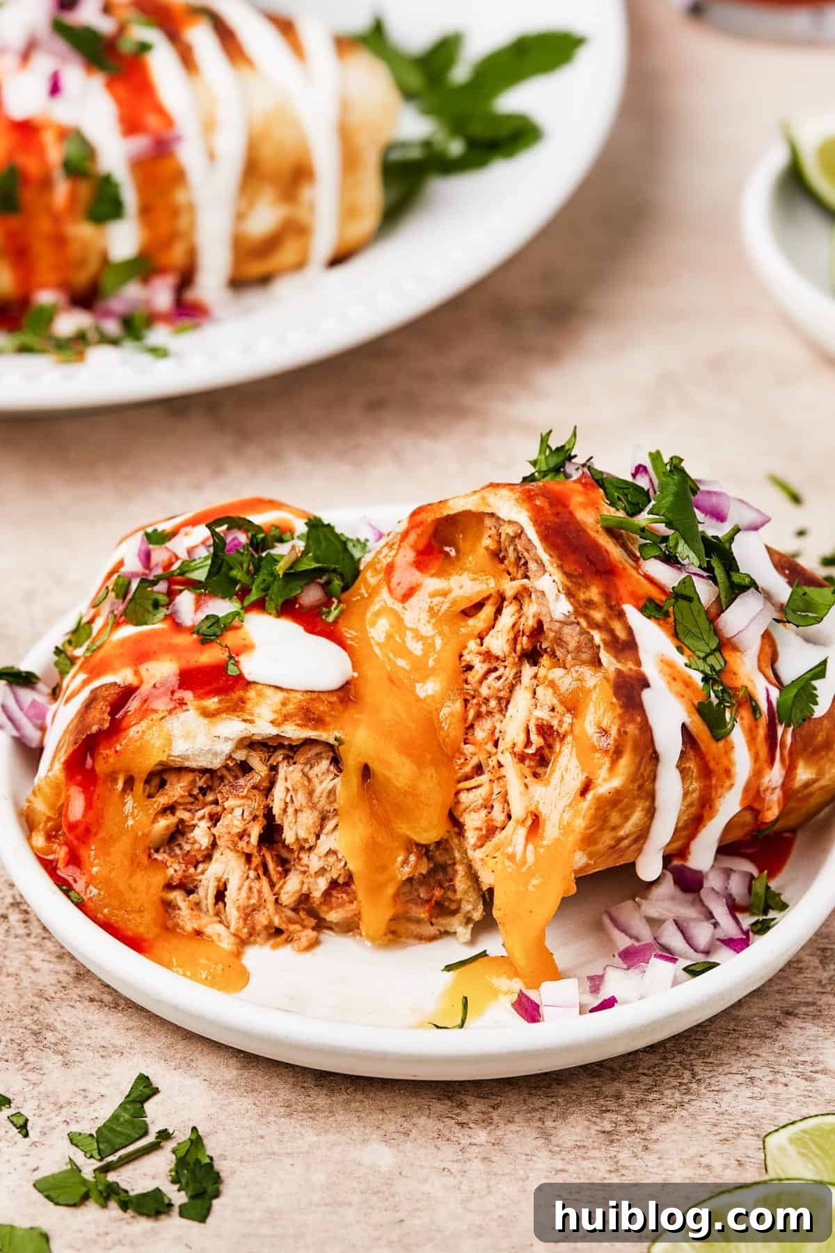 A plate with a chimichanga cut in half to show the filling.