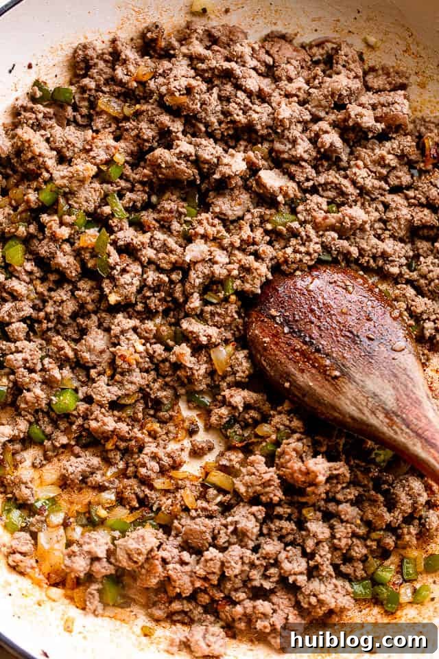 Browning ground beef in a skillet.