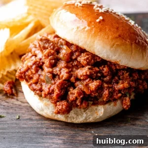 sloppy joe hamburger placed on a wooden board