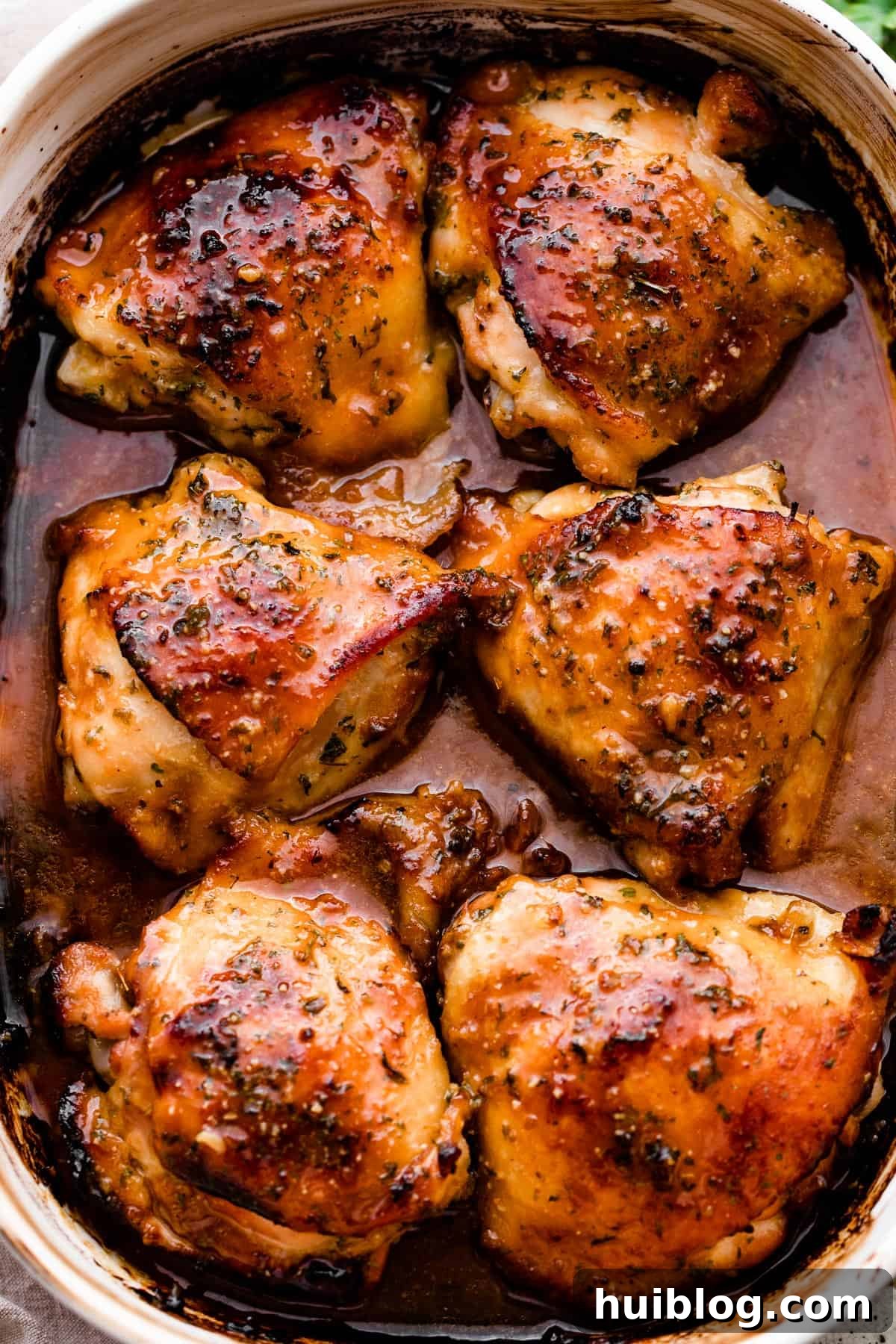 overhead shot of a baking dish with six honey garlic baked chicken thighs.