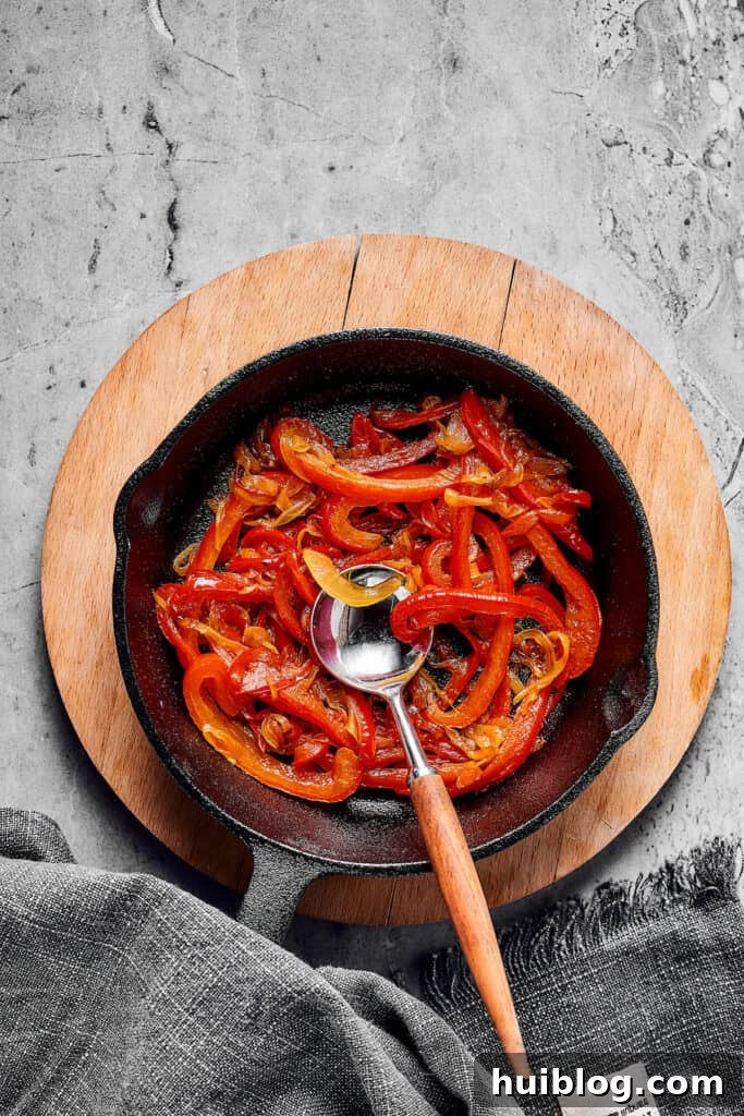 Cooked vegetables in a cast-iron skillet.
