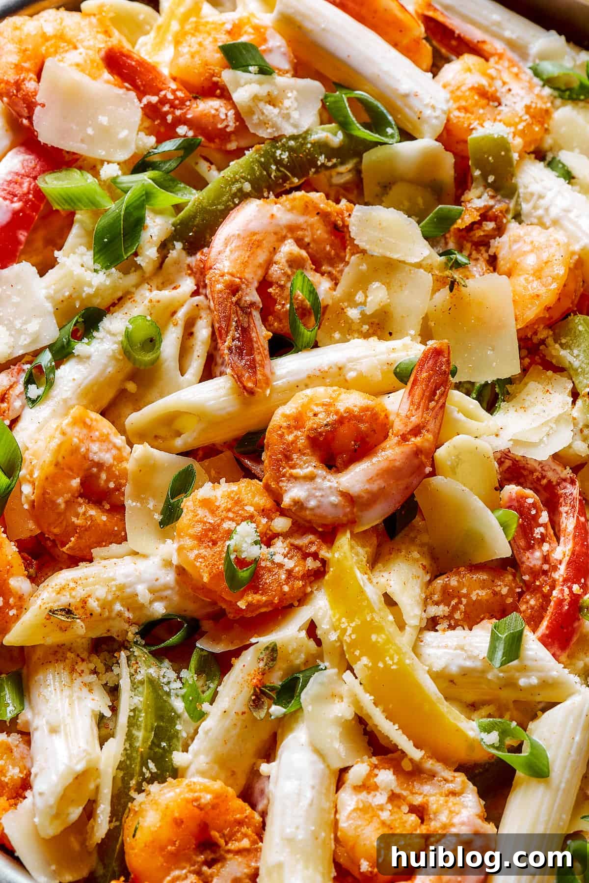 Close-up shot of Rasta pasta, highlighting the creamy sauce, shrimp, and colorful bell peppers.