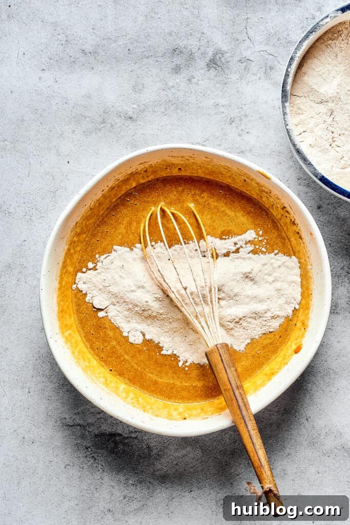 Swirled Pumpkin Cream Cheese Muffins 3 A bowl of pumpkin batter with dry ingredients just added, ready for gentle whisking to combine.