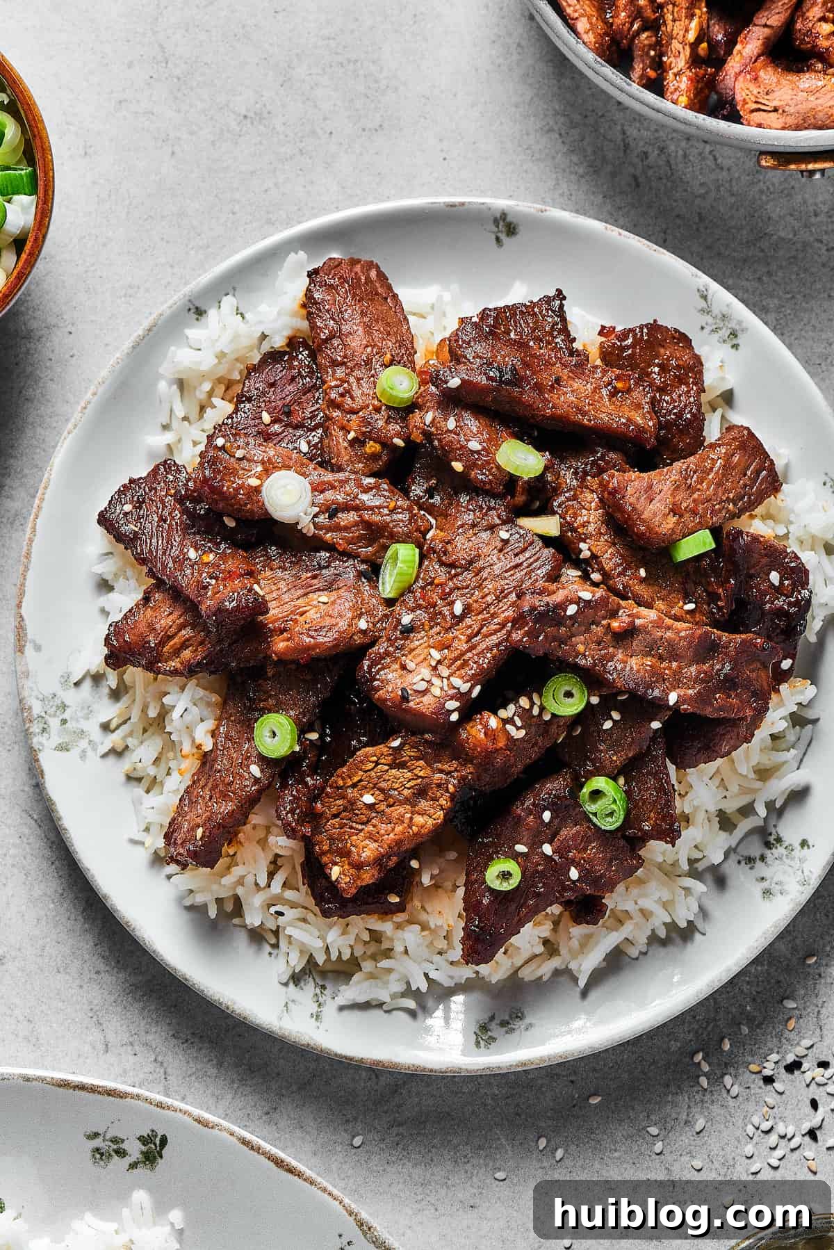 A plate of bulgogi with other dishes visible at the edges of the shot.