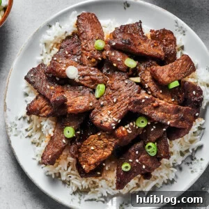 A plate of bulgogi with other dishes visible at the edges of the shot.