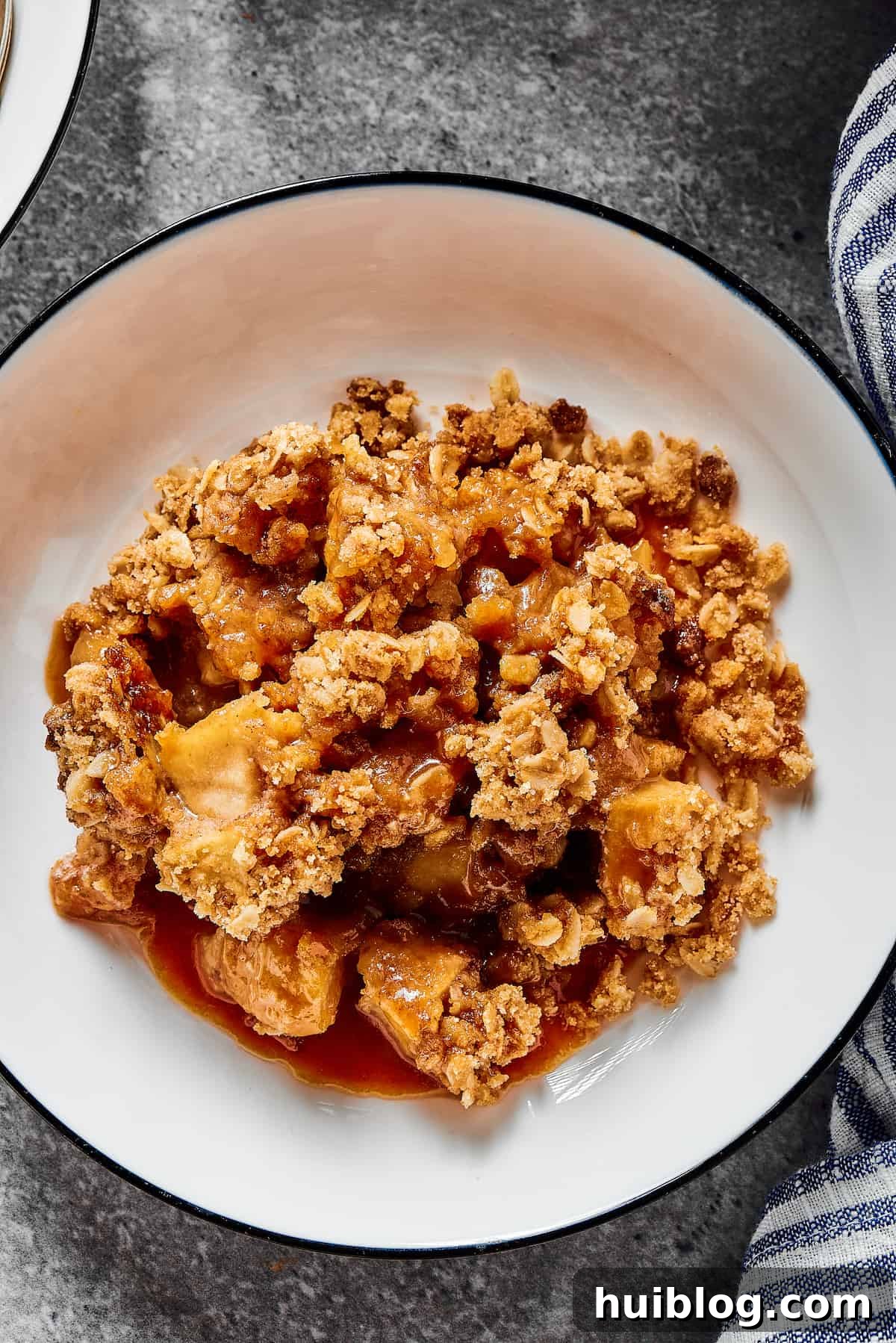 An overhead shot of baked apple dessert with an oat crisp topping.