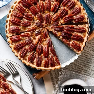 A slice of pie on a small serving dish, next to the larger pie.