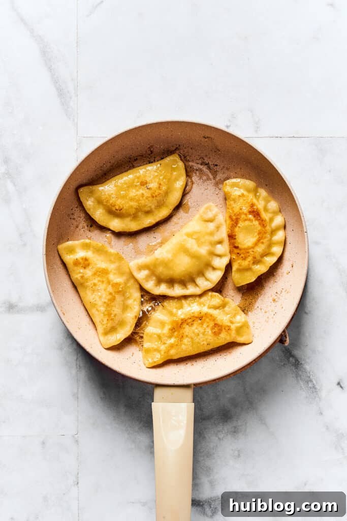 Crafting Perfect Pierogi at Home 9 A skillet of pierogi frying in butter.