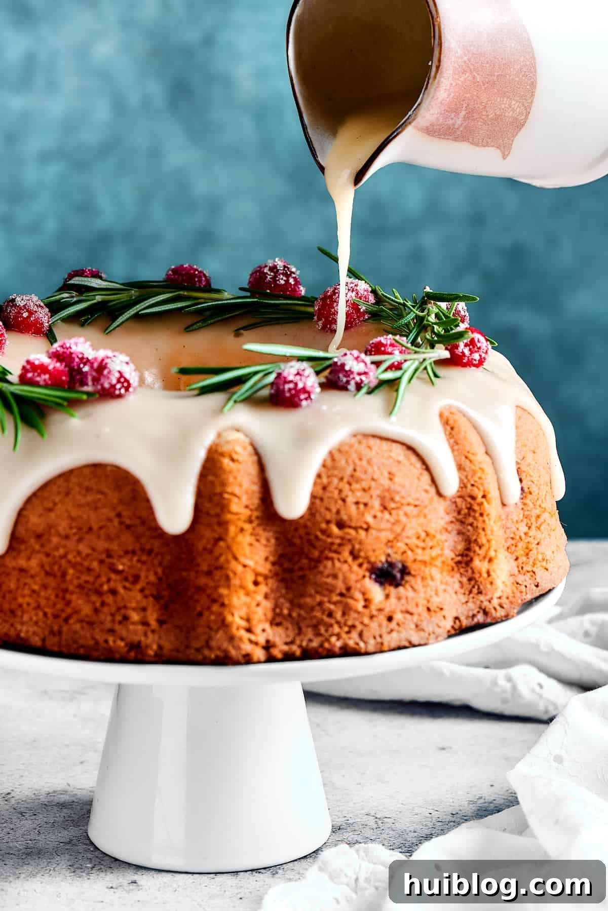 A luscious orange glaze being poured generously over a perfectly baked Bundt cake, creating a beautiful cascading effect.