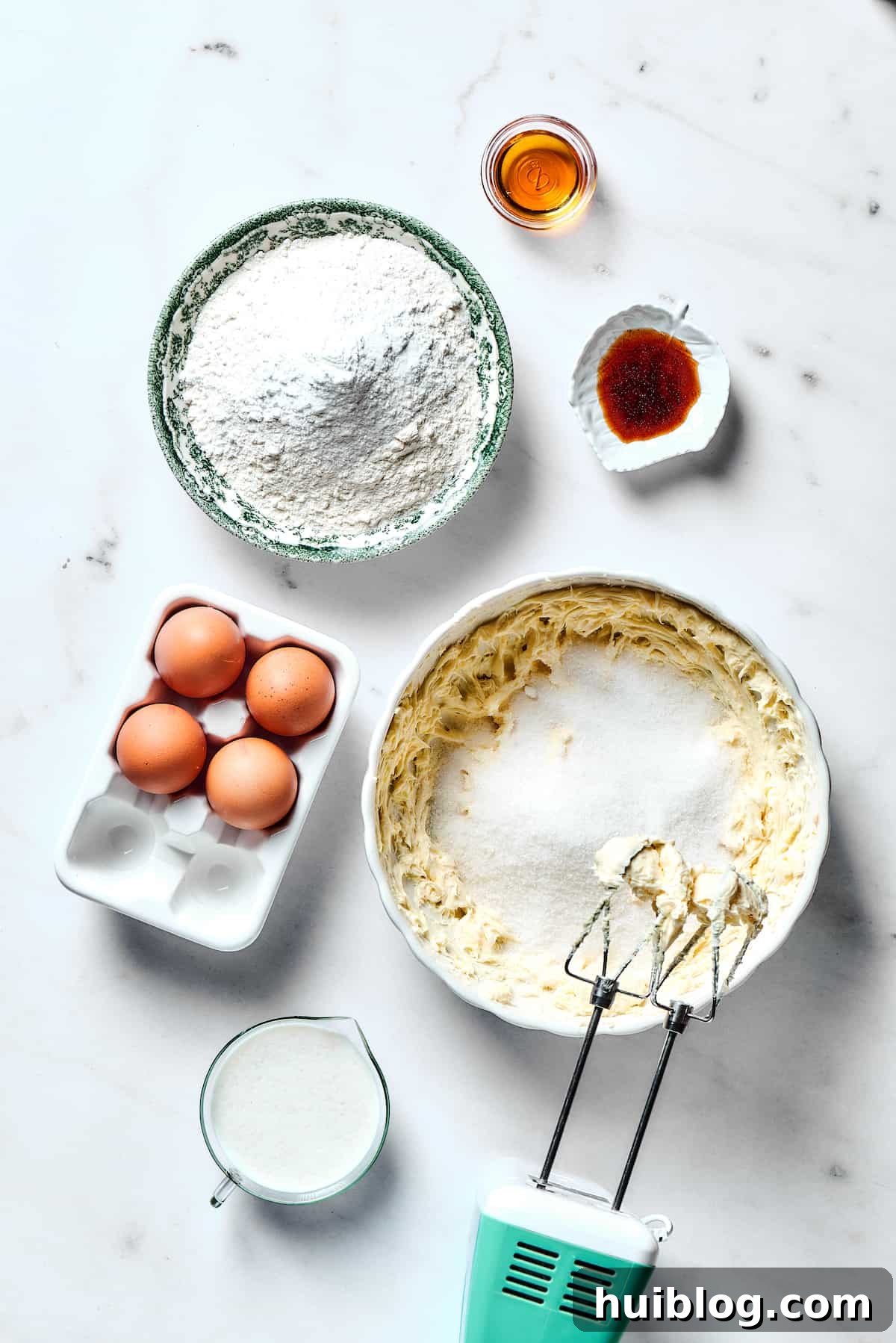 Unsalted butter and granulated sugar being creamed together in a stand mixer, creating a light and fluffy mixture.