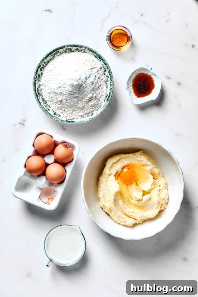 Adding large eggs one at a time to the wet mixture in a stand mixer.