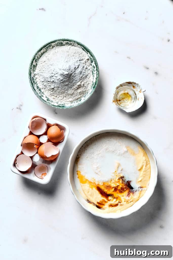 Wet ingredients mixing in a bowl, with a separate bowl of dry ingredients ready on the counter.