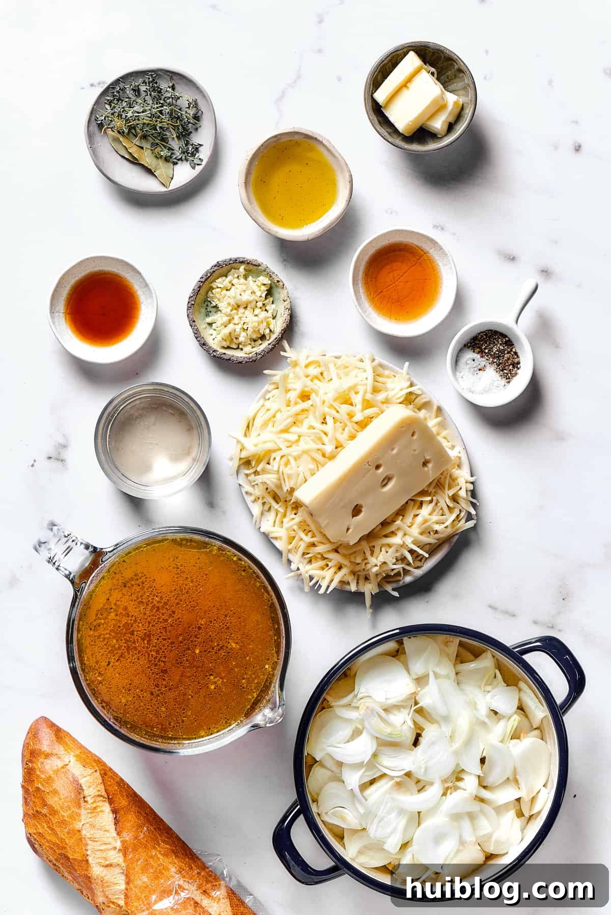 Caramelized Onion & Gruyère Soup 4 All the essential ingredients for French onion soup, neatly arranged on a kitchen work surface before cooking.