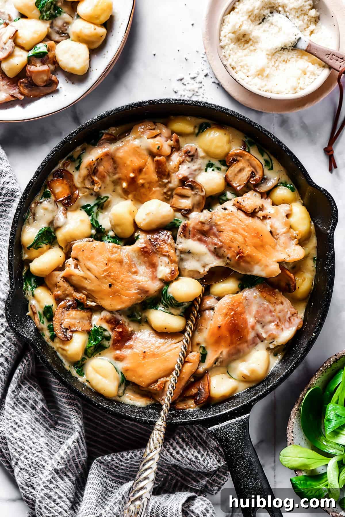 Creamy chicken and gnocchi in a cast-iron skillet, ready to serve.