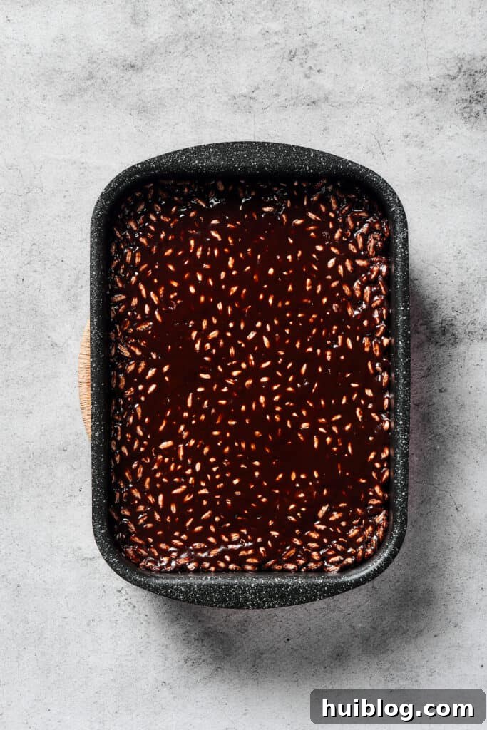 No-Bake Chocolate Crispy Treats 7 A finished pan of chocolate rice cereal treats, evenly pressed and cooling, ready for the topping.