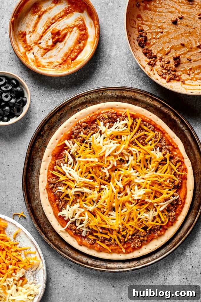 Fiesta Pie 6 An unbaked Mexican pizza, fully loaded with refried bean sauce, seasoned beef, and a generous covering of both cheddar and mozzarella cheese.