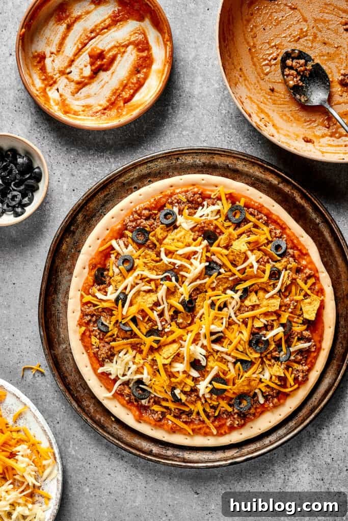 Fiesta Pie 7 Finely sliced black olives carefully sprinkled over the unbaked Mexican pizza, adding a touch of color and briny flavor.
