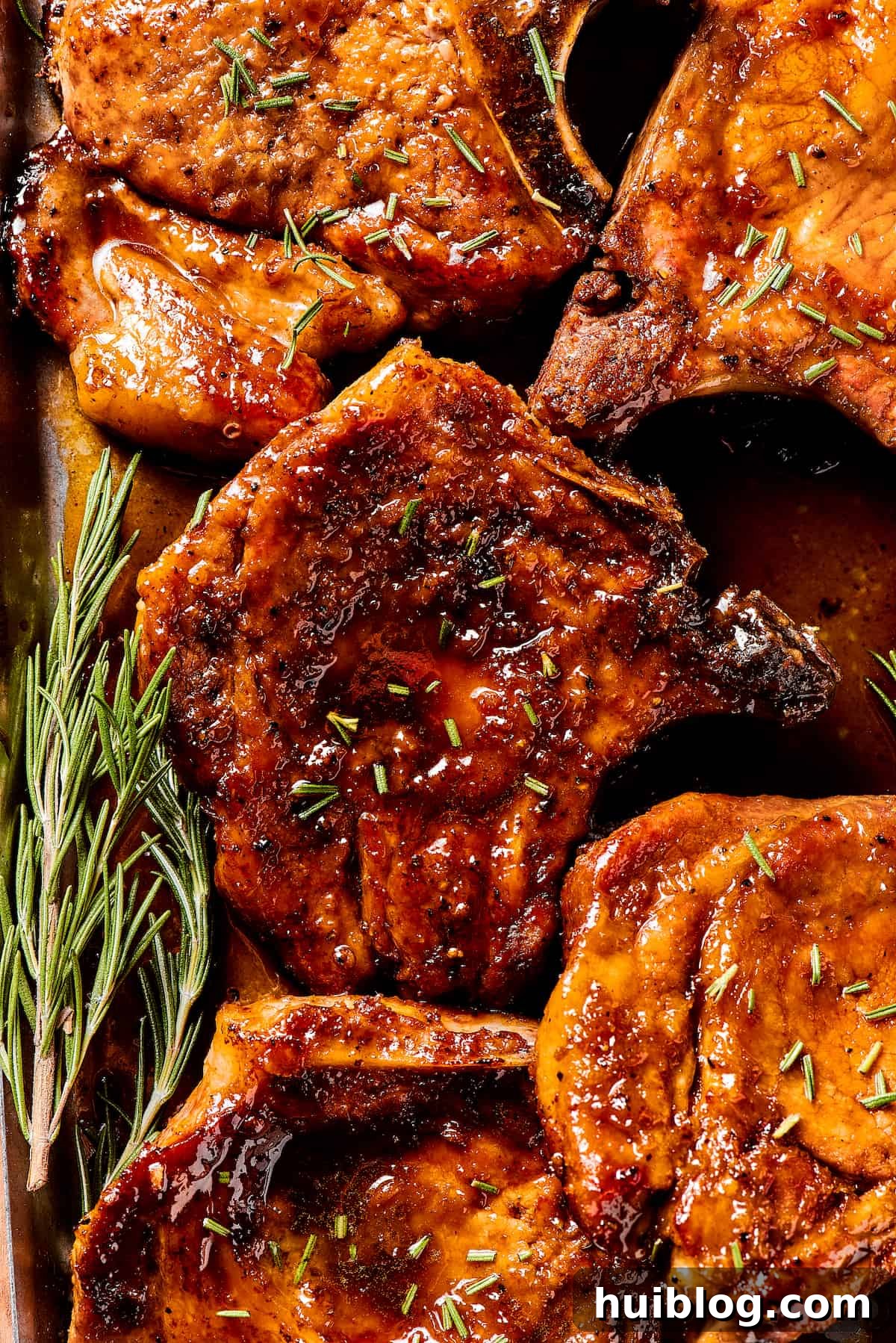 Gorgeous Brown Sugar Pork Chops may look fancy, but they are actually so simple to make! Savory, pan-fried chops with brown sugar glaze. Brown sugar pork recipe with fresh green herbs sprinkled on top.