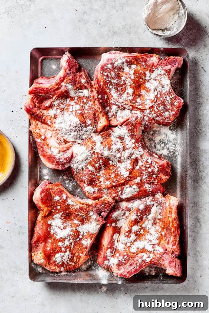 Gorgeous Brown Sugar Pork Chops may look fancy, but they are actually so simple to make! Savory, pan-fried chops with brown sugar glaze. Pork chops neatly arranged on a plate, generously sprinkled with seasoned flour mixture.