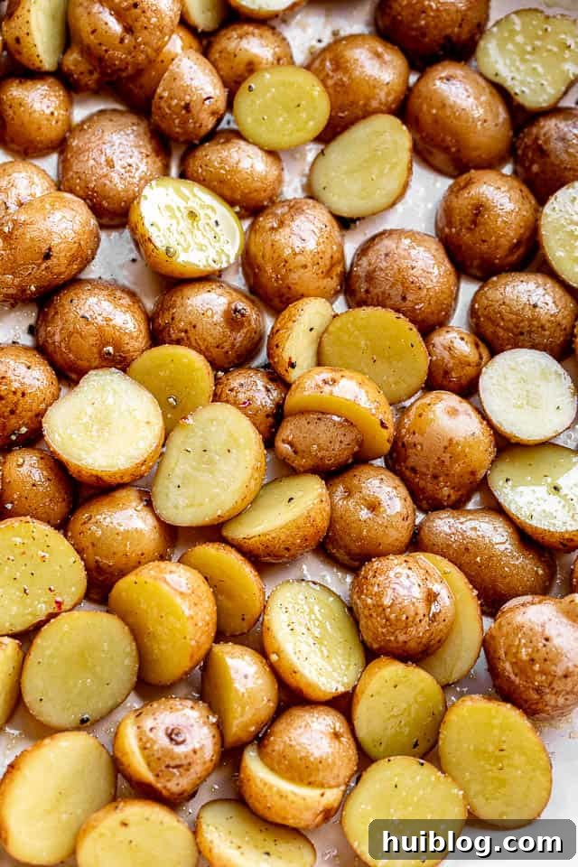 One-Pan Balsamic Chicken and Potatoes 4 Top view of yellow Yukon Gold potatoes, quartered and ready for seasoning, highlighting their smooth texture and even cuts.