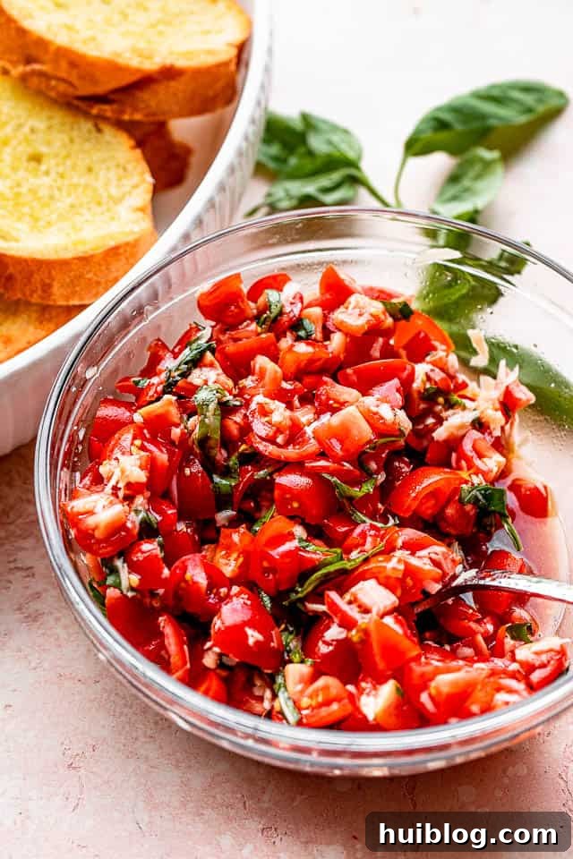 tomato salad in a salad bowl set next to toasted garlic bread