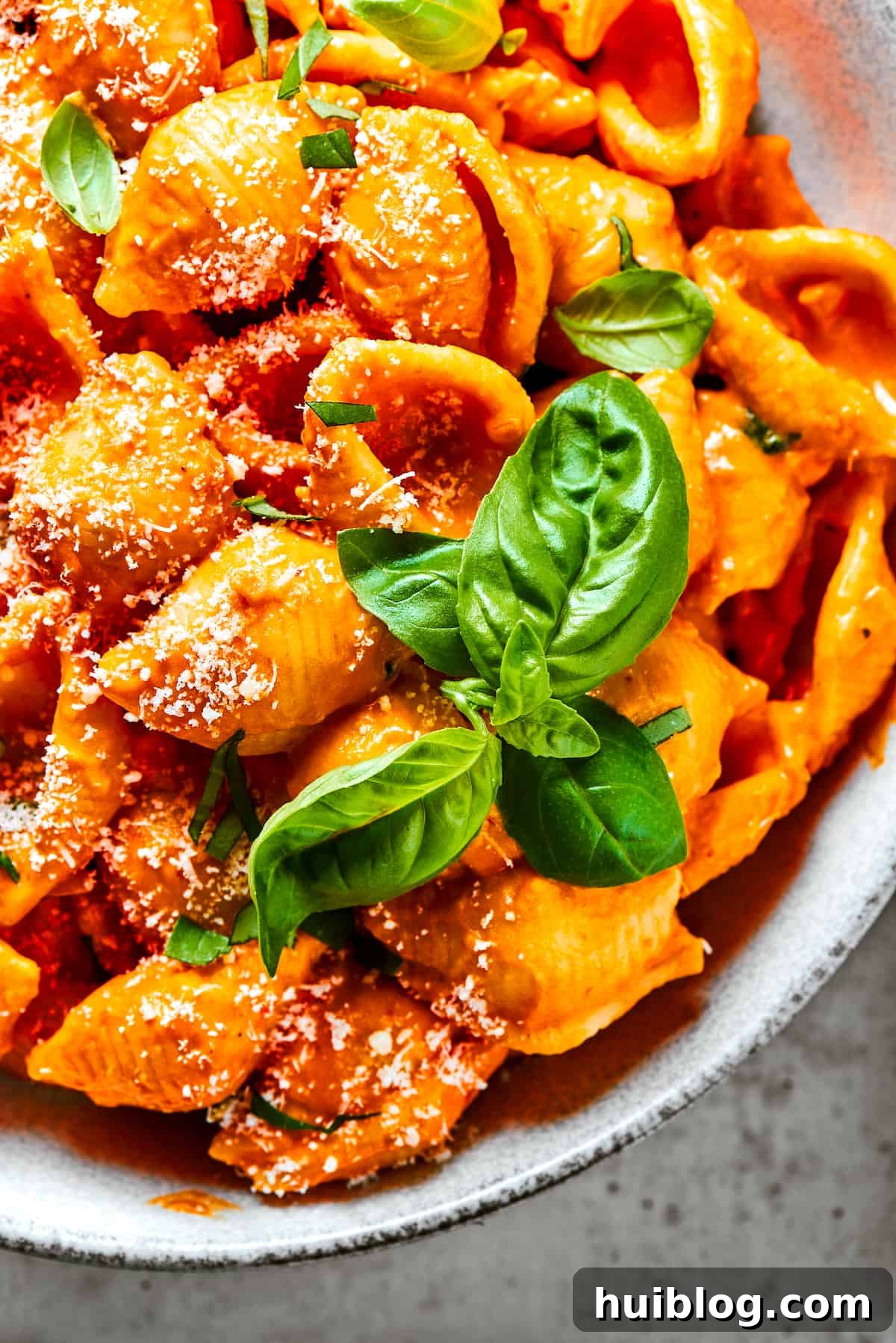 Gigi Hadid's Popular Pasta: Vodka Optional 11 Pasta shells glistening in creamy tomato sauce, generously sprinkled with fresh parmesan cheese.