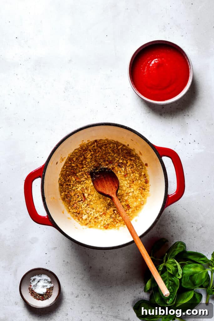 Gigi Hadid's Popular Pasta: Vodka Optional 5 Garlic and shallots gently cooking in a saucepan, forming the aromatic base for the sauce.