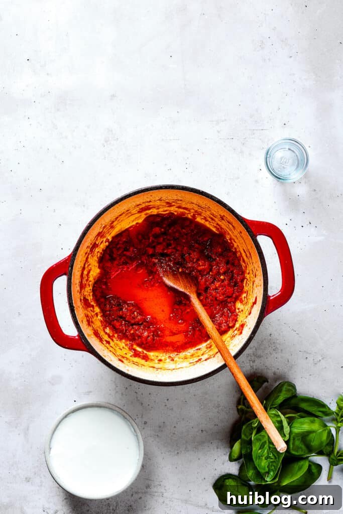 Gigi Hadid's Popular Pasta: Vodka Optional 7 Adding key seasonings to the simmering pot, enhancing the flavor profile.