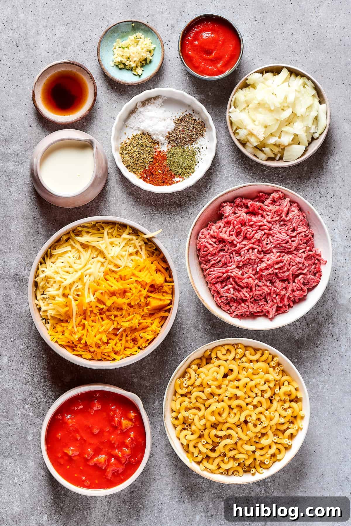 Ingredients for cheeseburger casserole, measured and arranged neatly on a work surface.