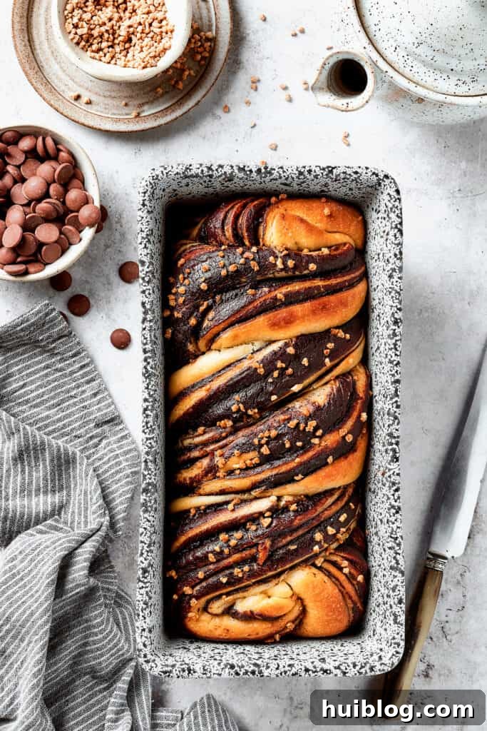 A baked chocolate babka in a loaf pan.